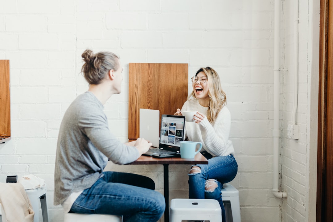 Two people sitting across a table mid-conversation, building trust over a shared meal