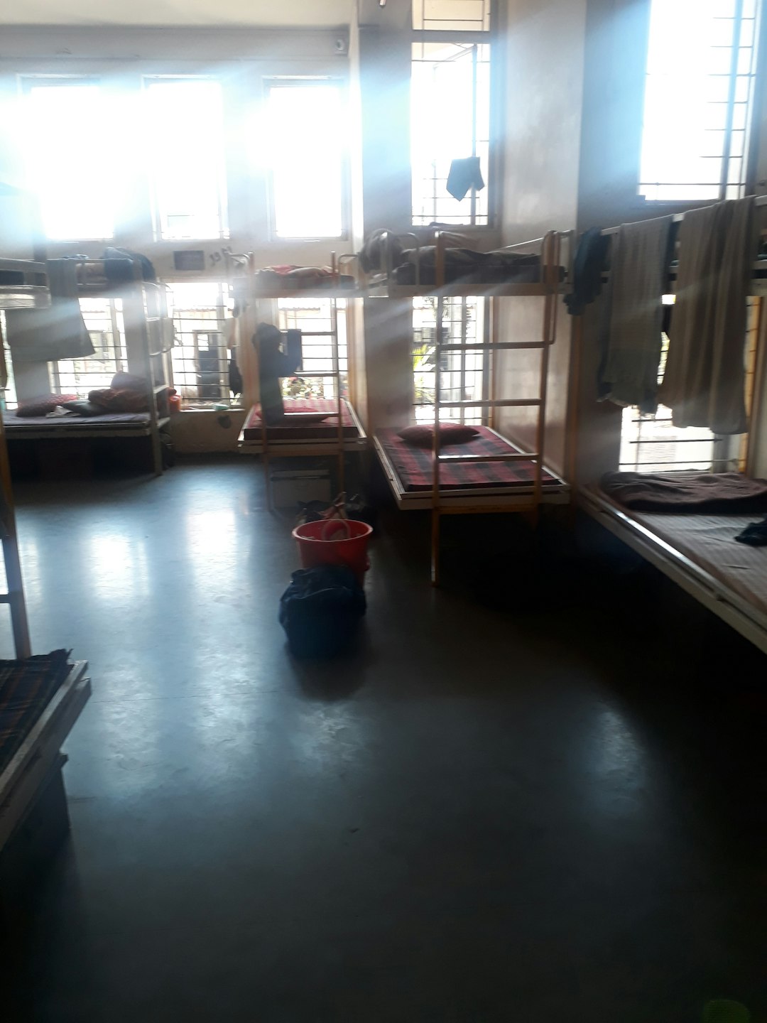 Sunlit bunk beds in a budget hostel dormitory